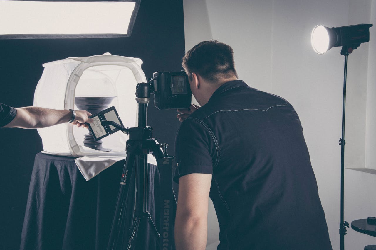 The Art of Drawing Readers In: Your attractive post title goes here Photographer capturing product in a studio setup with lighting gear and camera.