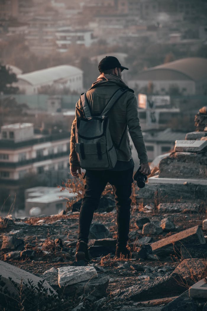 who-we-are A man explores an urban setting with a camera, capturing the cityscape in the background.